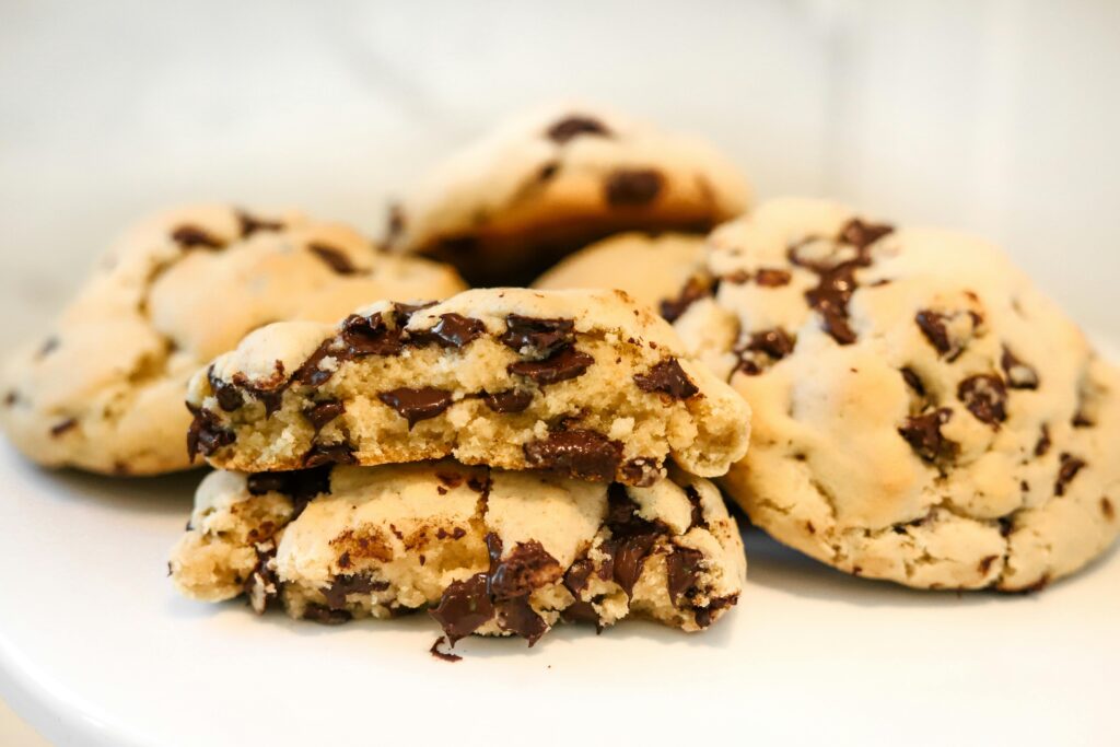 Close-up of freshly baked chocolate chip cookies, showcasing their gooey texture, ideal for food bloggers and bakery promotions.